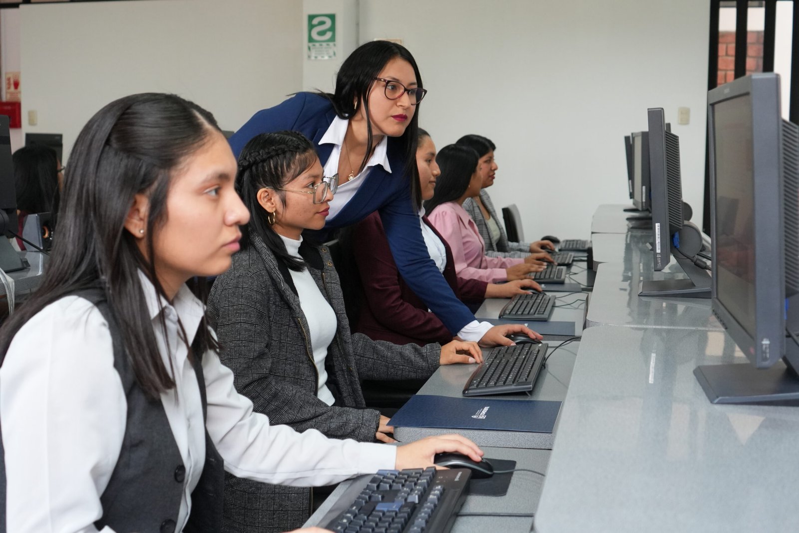 Students working at computers at a vocational institute in Peru